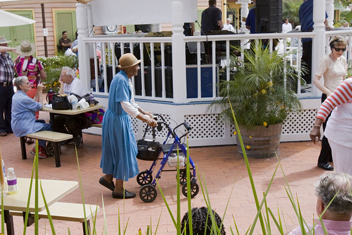 Die alte Dame schiebt im Takt ihre Gehhilfe um den Pavillon